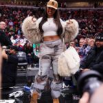 Megan Thee Stallion Attends the Bulls vs Celtics Game in a DSquared Fur Coat, Who Decides War Cargo Pants, and a YSL Niki Oversized Fur Bag