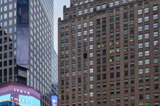 Kim Kardashian Promotes Skims Swim with a Blue Bikini Clad Blow Up Doll in Times Square