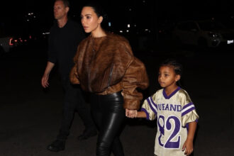 Kim Kardashian Stepped Out with her Son Psalm West in a Brown Fur Bomber Jacket with Black Leather Leggings