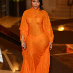 Jayda Cheaves Wears Laquan Smith Orange Spring 2023 Gown and Brandon Blackwood Bomb Accessories to the Black Arts Council Benefit
