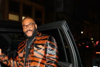 Tyler Perry Promotes Six Triple Eight in a House of Gray Custom Pony Hair Jacket