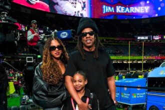 Jay-Z Attended the Superbowl in an All-Black Look with Blue Ivy in a Black Balenciaga Leather Jacket and Rumi Rocking an Off-White Amiri Crossbody